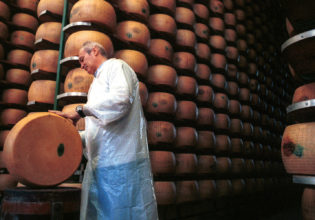 A consortium master checks the progress of the parmesan cheese for ageing in Parma, Italy.
