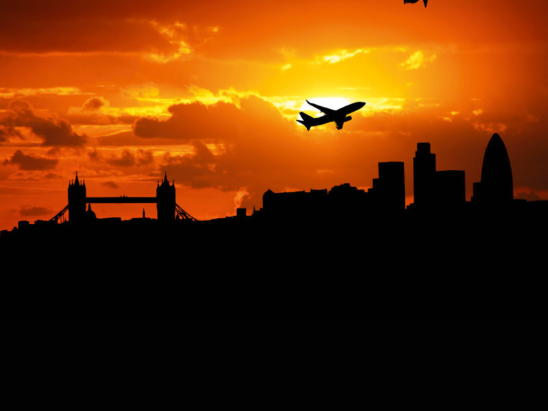 Jumbo jet flying over the London skyline.