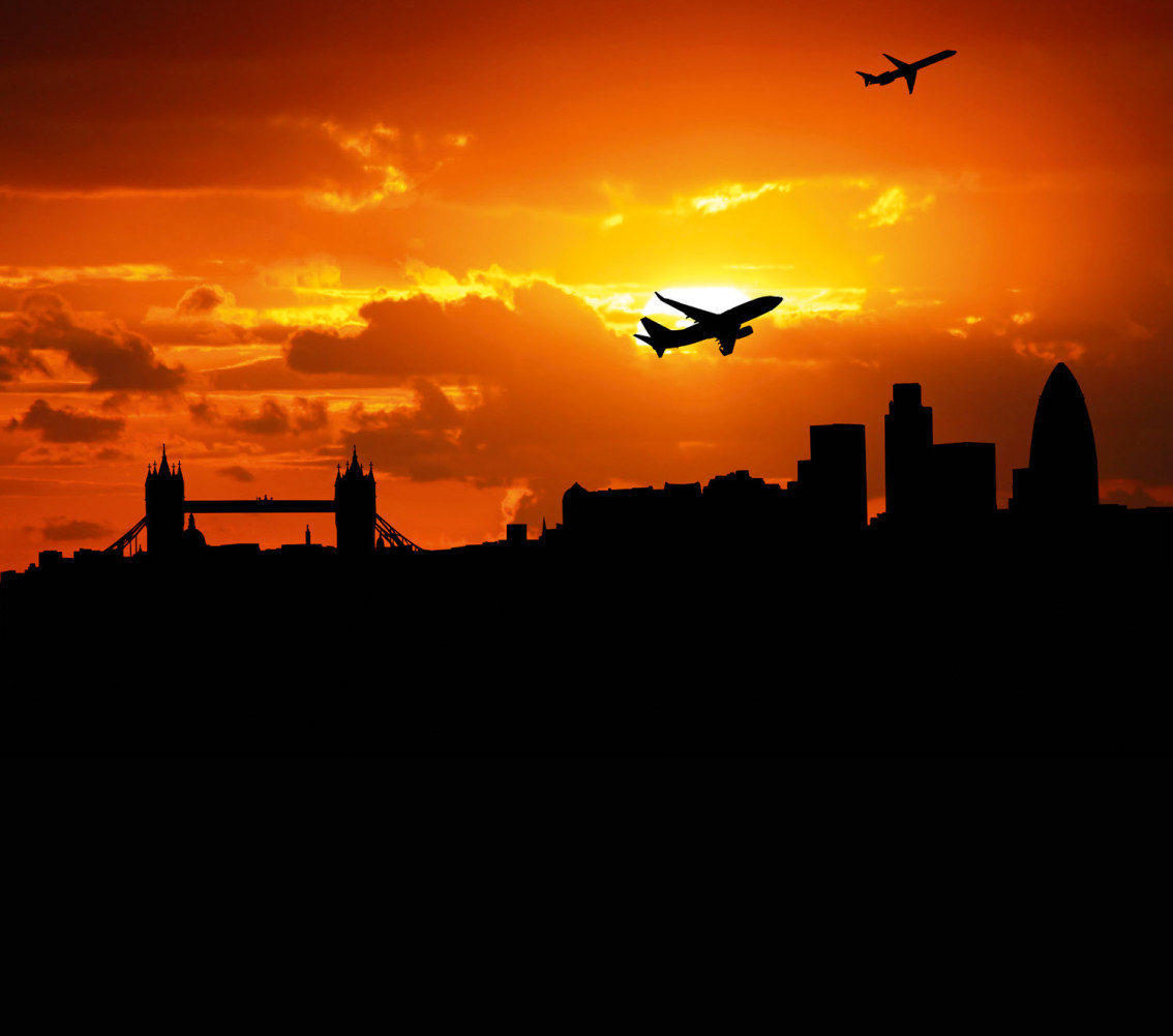 Jumbo jet flying over the London skyline.