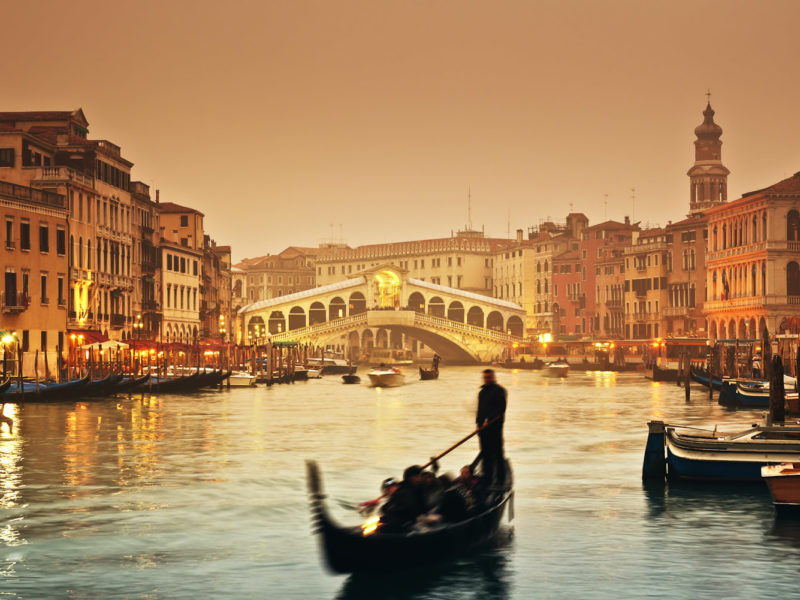Sunset over the Grand Canal and the famous Rialto Bridge.