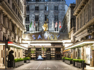 the entrance of The Savoy Hotel London at night