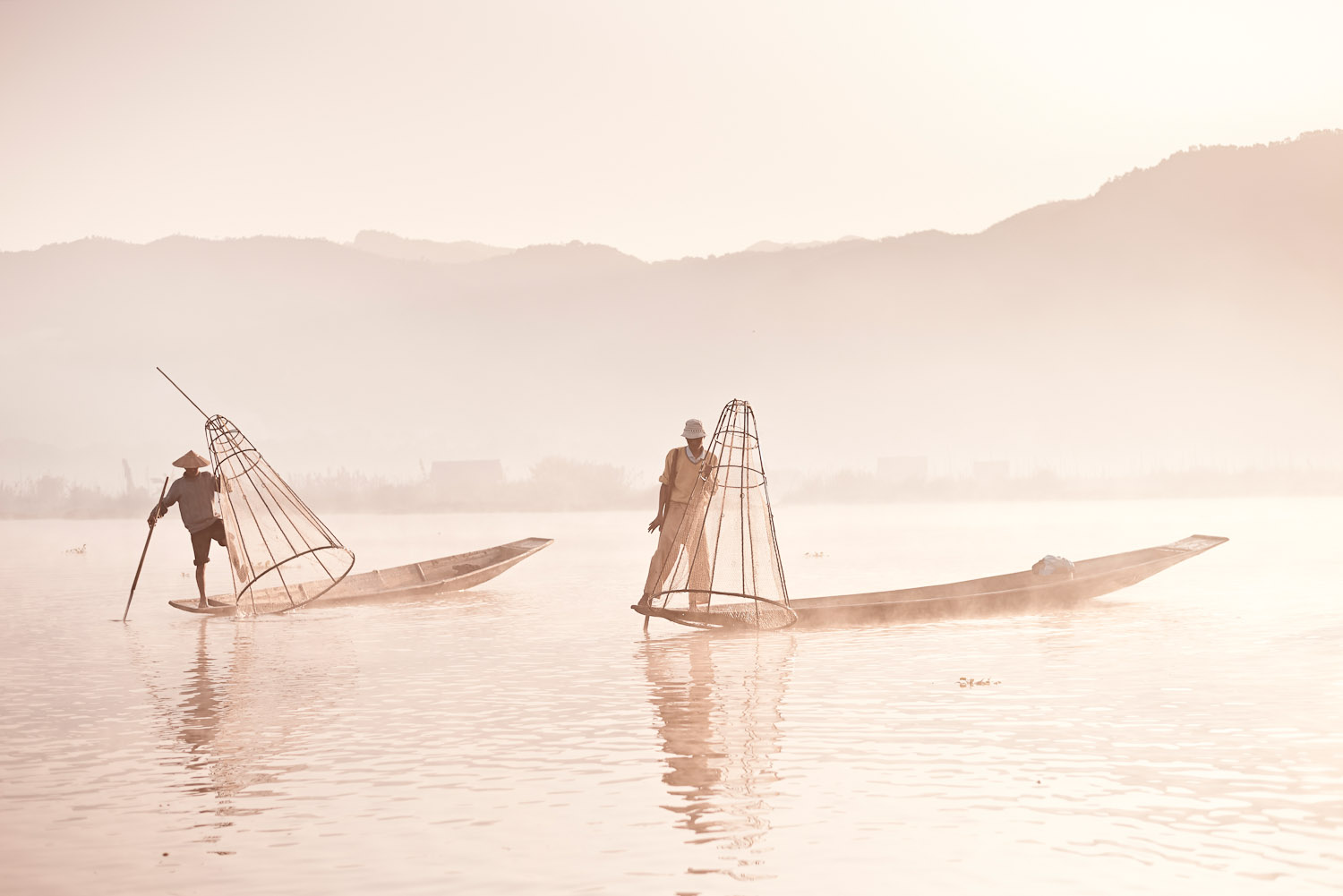 First light hits Inle Lake and the cone-fishermen start their working day.