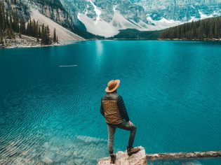 Man stands beside Moraine Lake