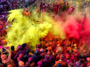 People celebrating in colour at the Holi Festival