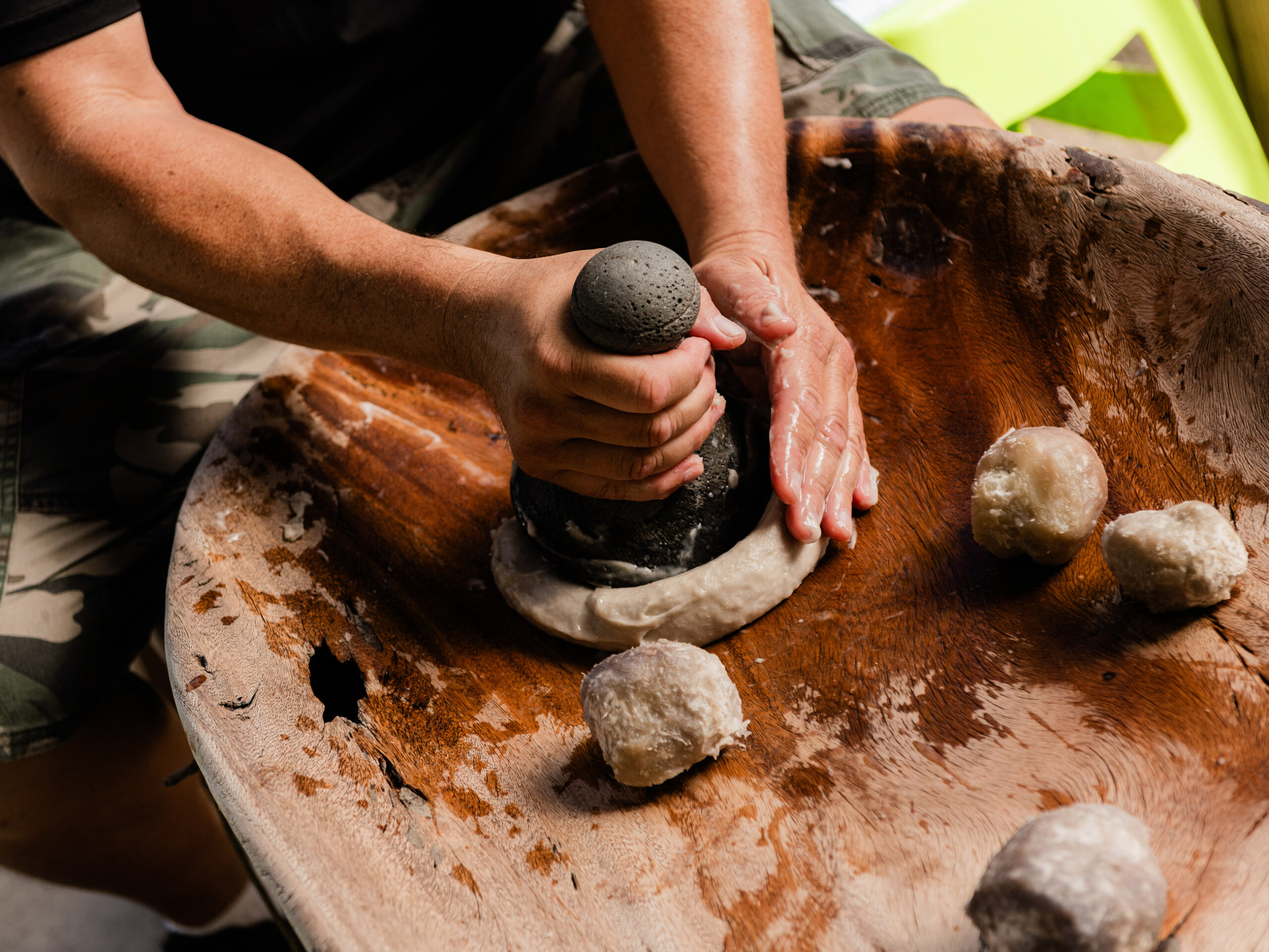 cooked kalo (taro) being pounded into poi in Hawaii