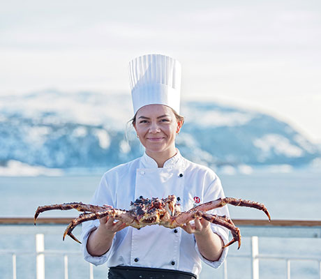 Chef with king crab onboard Hurtigruten