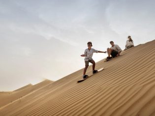 Family with child, Sandboarding in Dubai