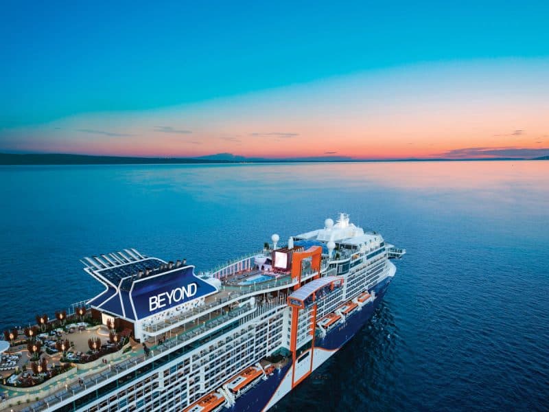 The Celebrity Beyond cruise ship in the ocean as the sun sets on the horizon. (Image: Celebrity Cruises)