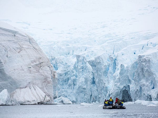 Zodiac in Antarctic Peninsula surrounded by icebergs, Antarctica