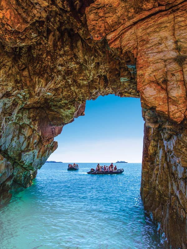 Going through natural rock arches. (Image: Lindblad Expeditions)