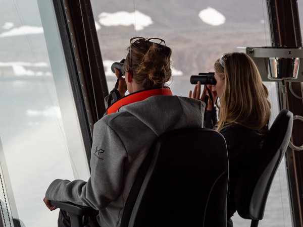 Two Hurtigruten passengers with binoculars