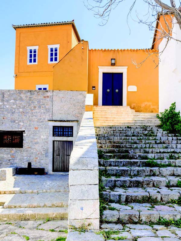 Looking up worn steps to the Lazaros Kountouriotis Mansion in Hydra, Greece.