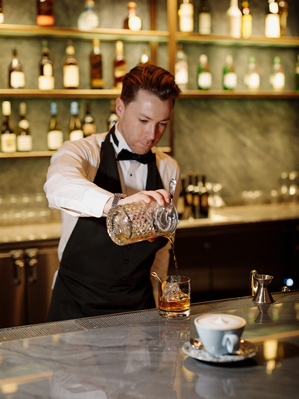 A mixologist prepares a cocktail in Air Canada Signature Suite in Vancouver International Airport