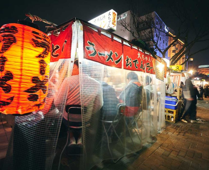 customers dining behind the curtains inside a Yatai food stall along Fukuoka