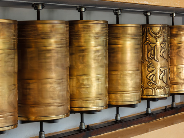 golden prayer wheels inside Tsuglagkhang complex