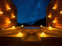 bright lamps surrounding Onsen Hot Pools at night