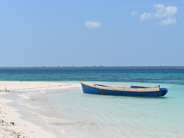 a boat docked on the side of the beach at Patawan Island