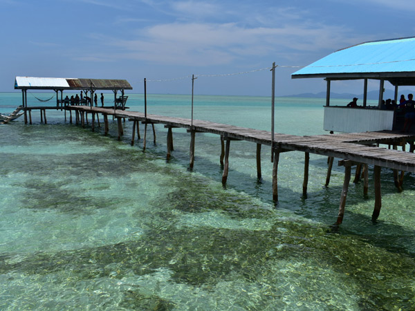 a wooden stilted walkway on the shallow waters of Onok Island, Balabac, Palawan, Philippines