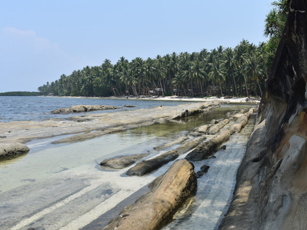 a natural runway and a palm-fringed shore on the background at Timbayan Rock Formations, Balabac, Palawan, Philippines