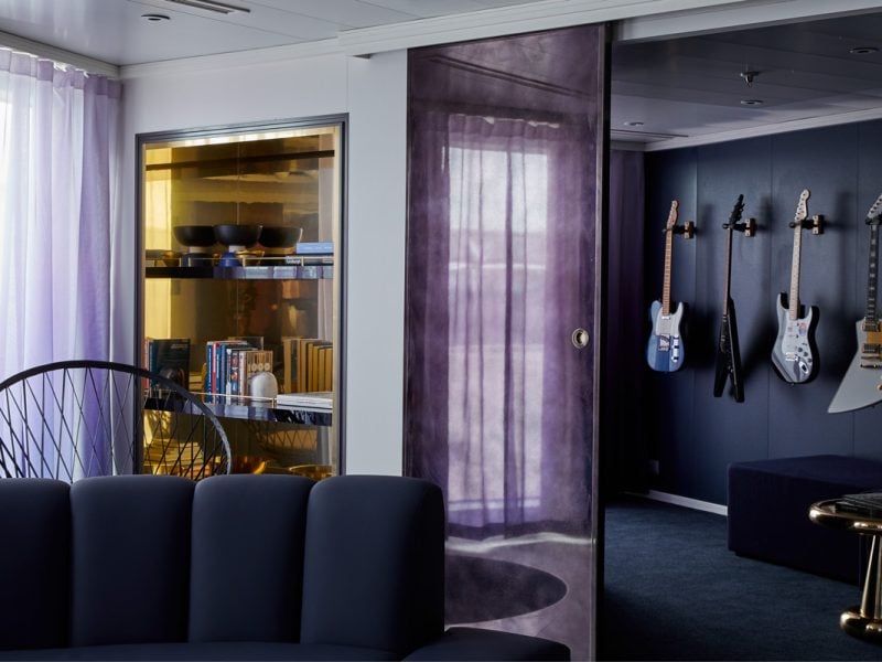 a media room stocked with four guitars at the massive suite, Virgin Voyages’ Resilient Lady