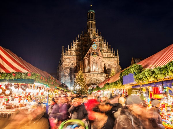 a Christmas market in Nuremberg brightly filled with people