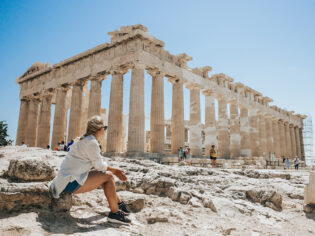 Woman relaxing while looking at Parthenon temple Greece