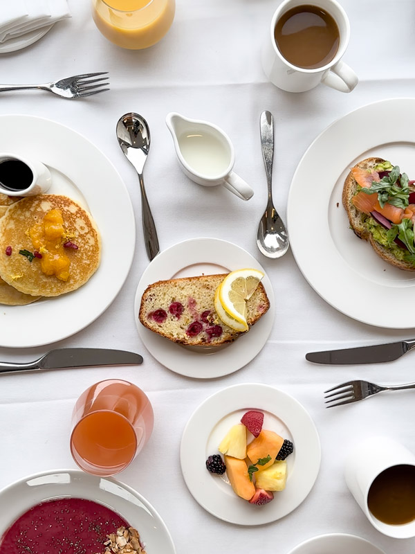 a breakfast spread with pancakes drizzled in Canadian maple syrup
