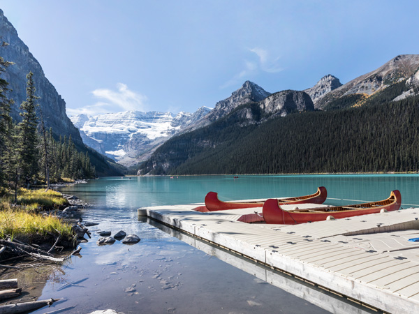 a scenic view of Lake Louise with boats on the side
