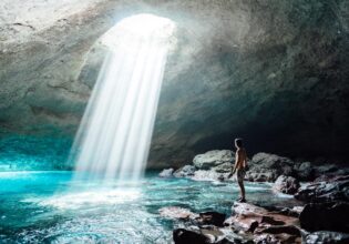 A man inside the Blue Cave on Tanna in Vanuatu