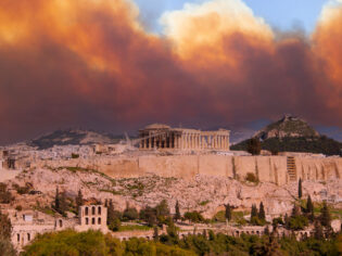 View of the Acropolis and the Parthenon against the background of smoke from fires in Athens