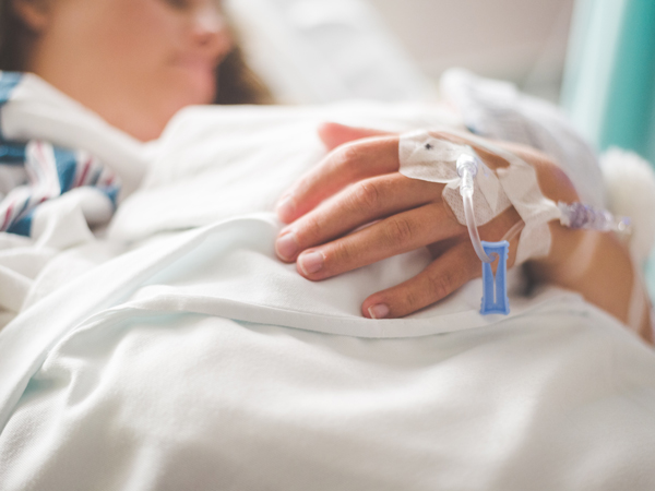 a close-up of a patient with normal saline infusion in hand