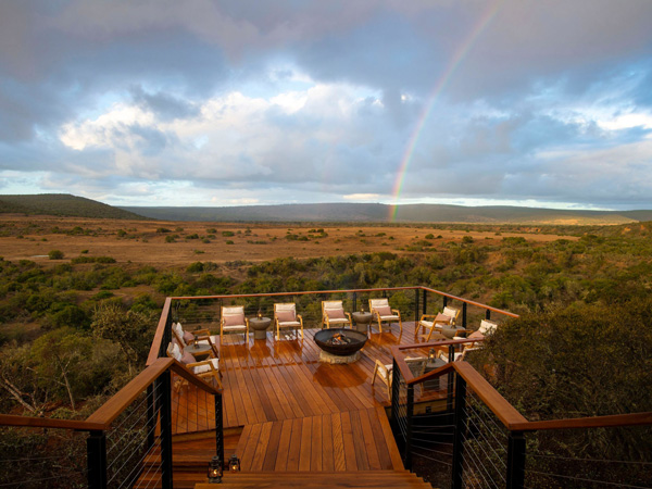 the outdoor safari deck with rainbow in the background at Shamwari Private Game Reserve