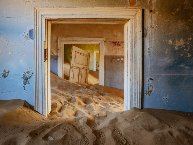 sand dunes covering the floor of an old house in Kolmanskop, Namibia