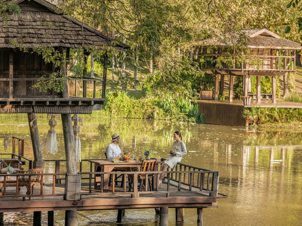 a couple relaxing in the open-air pavilion of Four Seasons Resort Chiang Mai