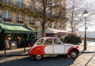 french vintage car on street in front of restaurants at ile-de-france in paris