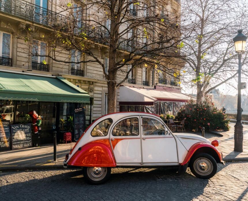 french vintage car on street in front of restaurants at ile-de-france in paris