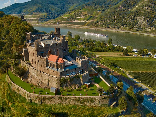 Viking Longship passing Castle on Hills in the Rhine Germany