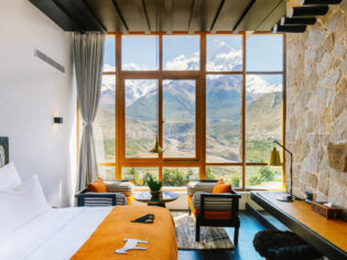 floor-to-ceiling windows frame views of the snow-capped Nilgiri Himal peaks at Shinta Mani Mustang