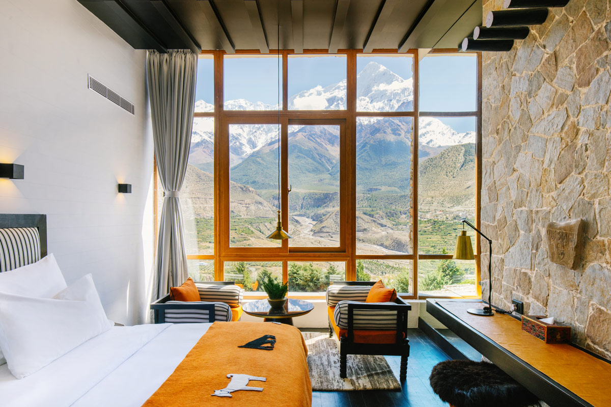 floor-to-ceiling windows frame views of the snow-capped Nilgiri Himal peaks at Shinta Mani Mustang