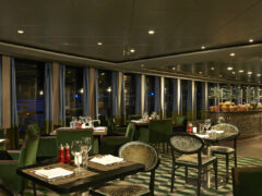 the dimly lit dining setting of Moderno Churrascaria, NCL Norwegian Dawn