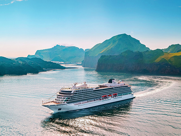 Viking Sky off-shore to the coastal town of Heimaey, Iceland. It is the largest island in the Vestmannaeyjar archipelago or Westman Islands. Along the coast is Eldfell volcanic cone.