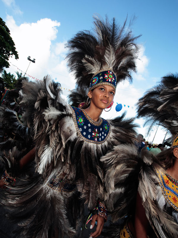 an Indigenous woman dressed in an elaborate costume at a folklore festival in the Brazilian Amazon