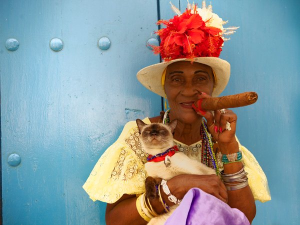 a Cuban woman smoking a large cigar