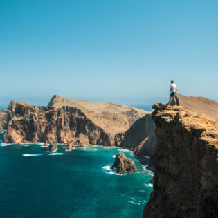 Man standing on cliff in Madeira