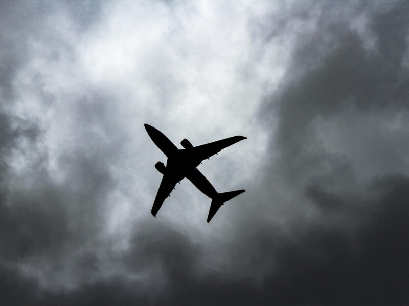 passenger plane under white clouds