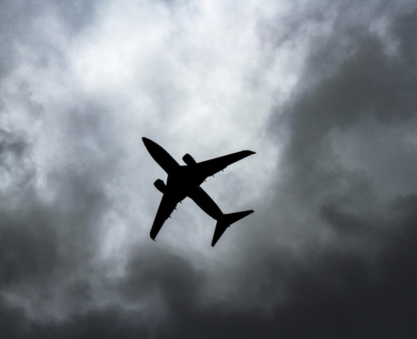 passenger plane under white clouds