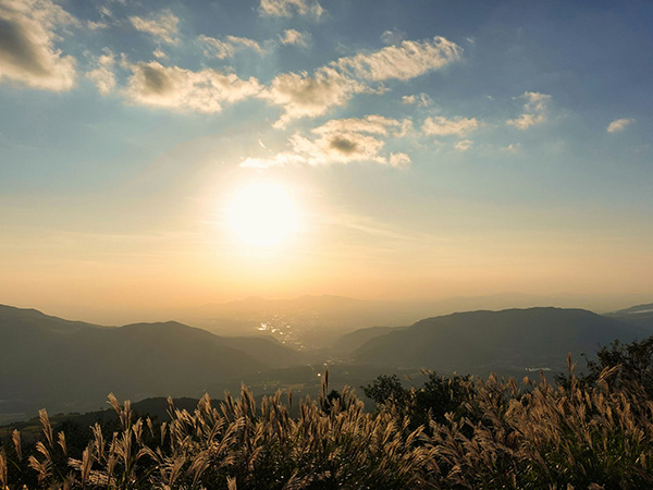 sun is setting over mount aso