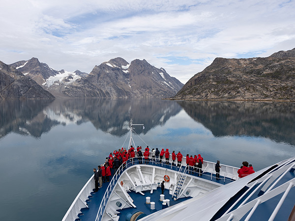 guests look at the view from the deck of silversea cruises in the arctic