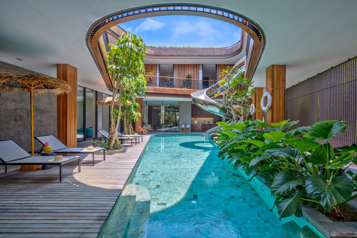 a pool with a spiral slide at Akashi Residence, Bali