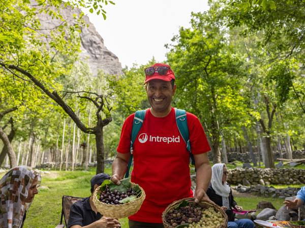 Guide Muneer Alam holding freshly picked cherries and mulberries